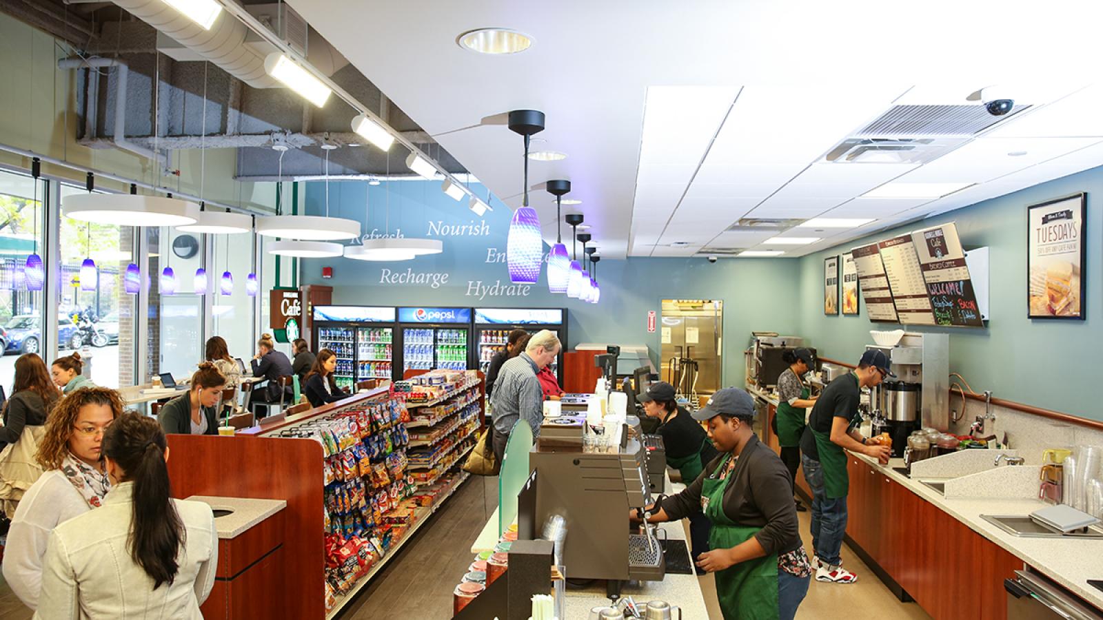 People at Starbucks making coffee.