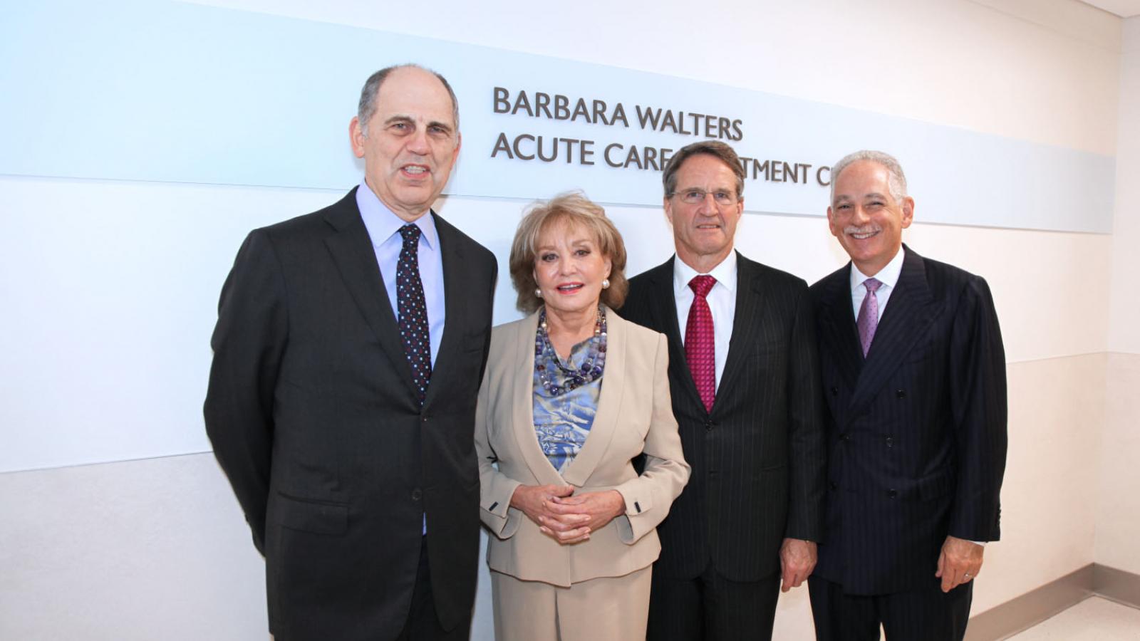 Barbara Walters pose with men at the Morgan Stanley Adult Emergency Department