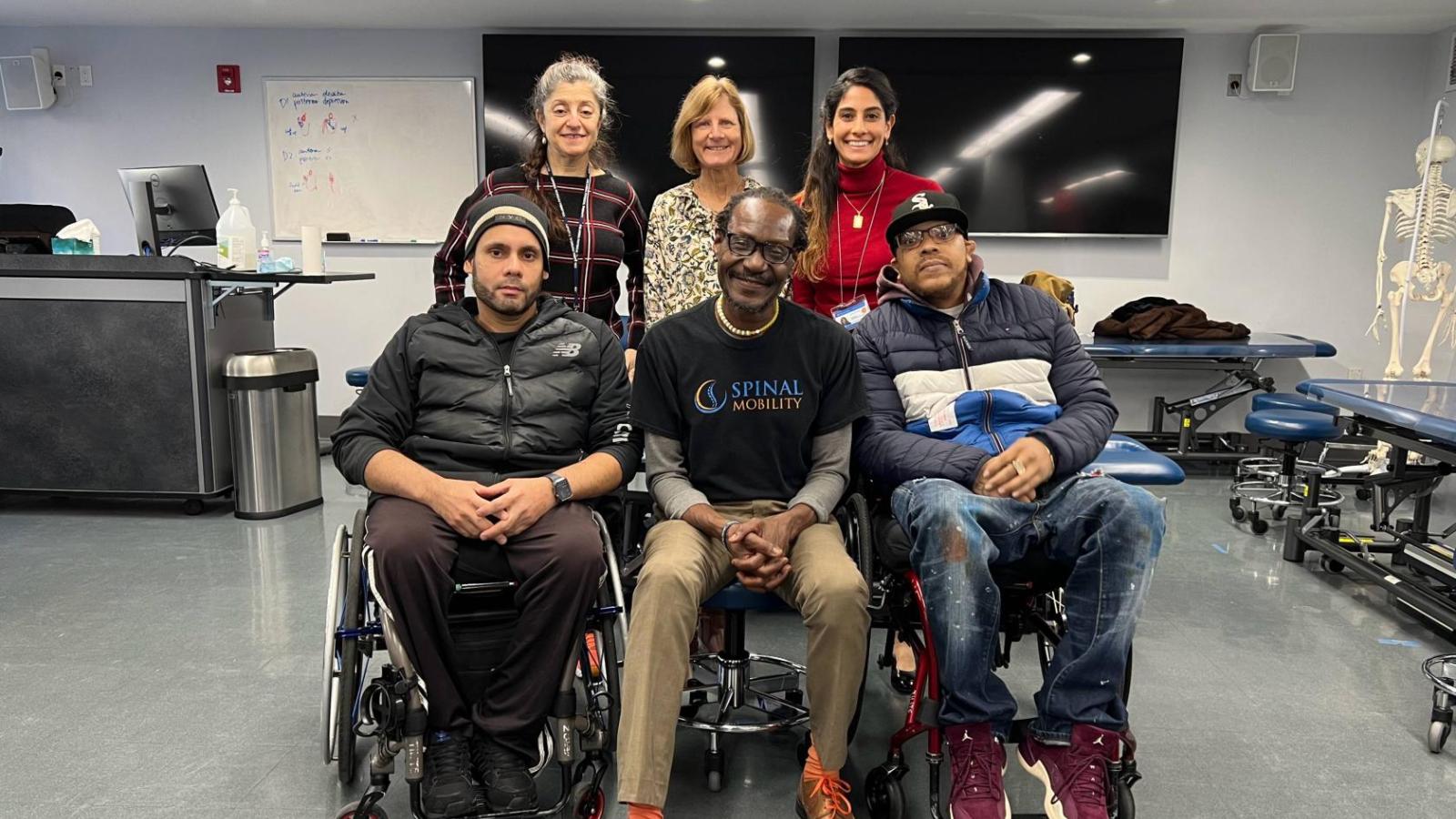 Faculty with Lawrence and patients.