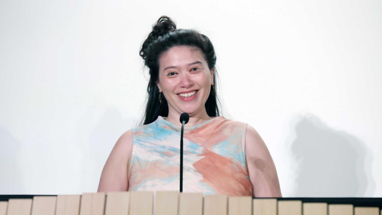 Student addresses attendees at a podium during a Columbia University white coat ceremony.