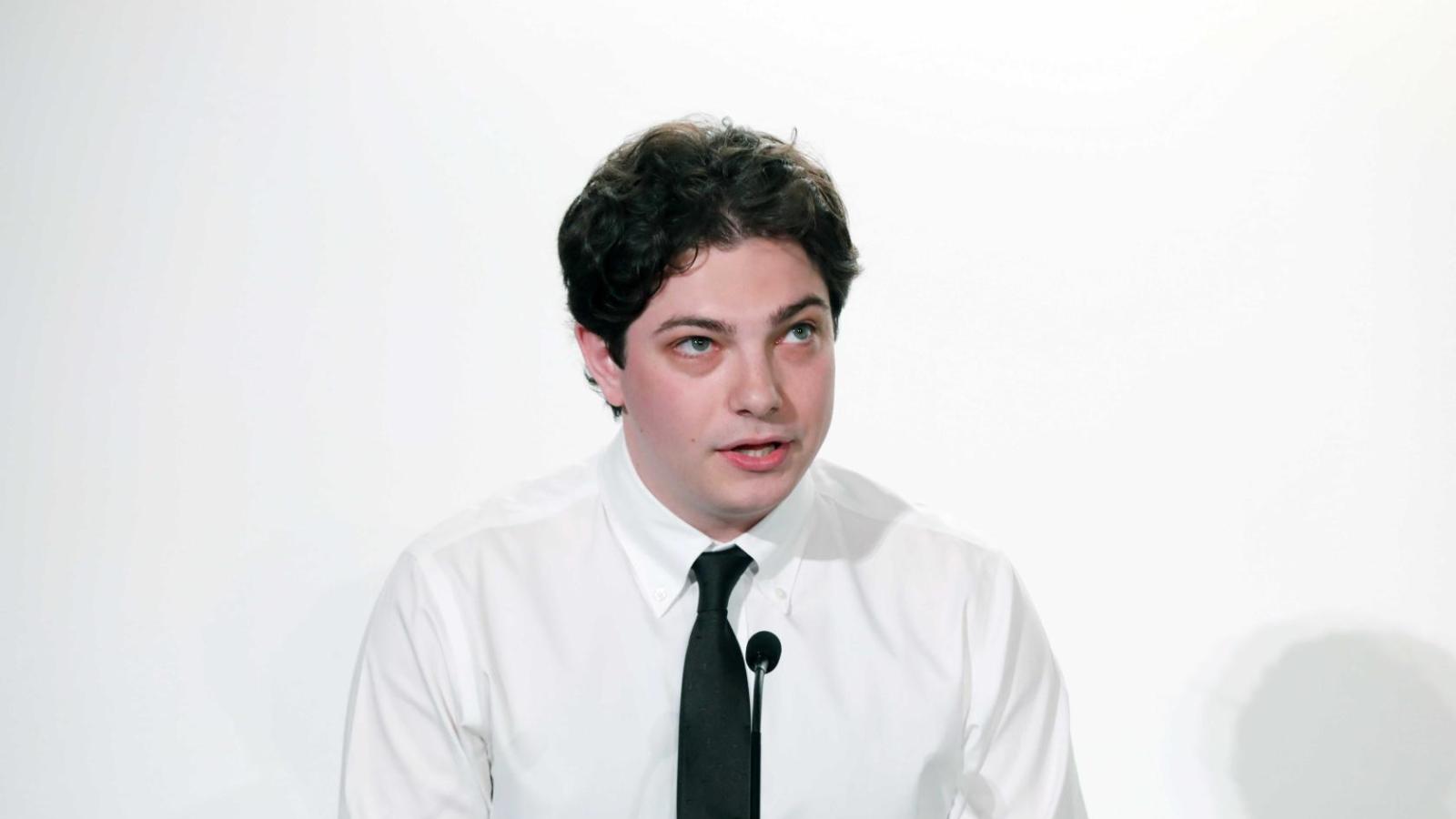 Student addresses attendees at a podium during a Columbia University white coat ceremony.