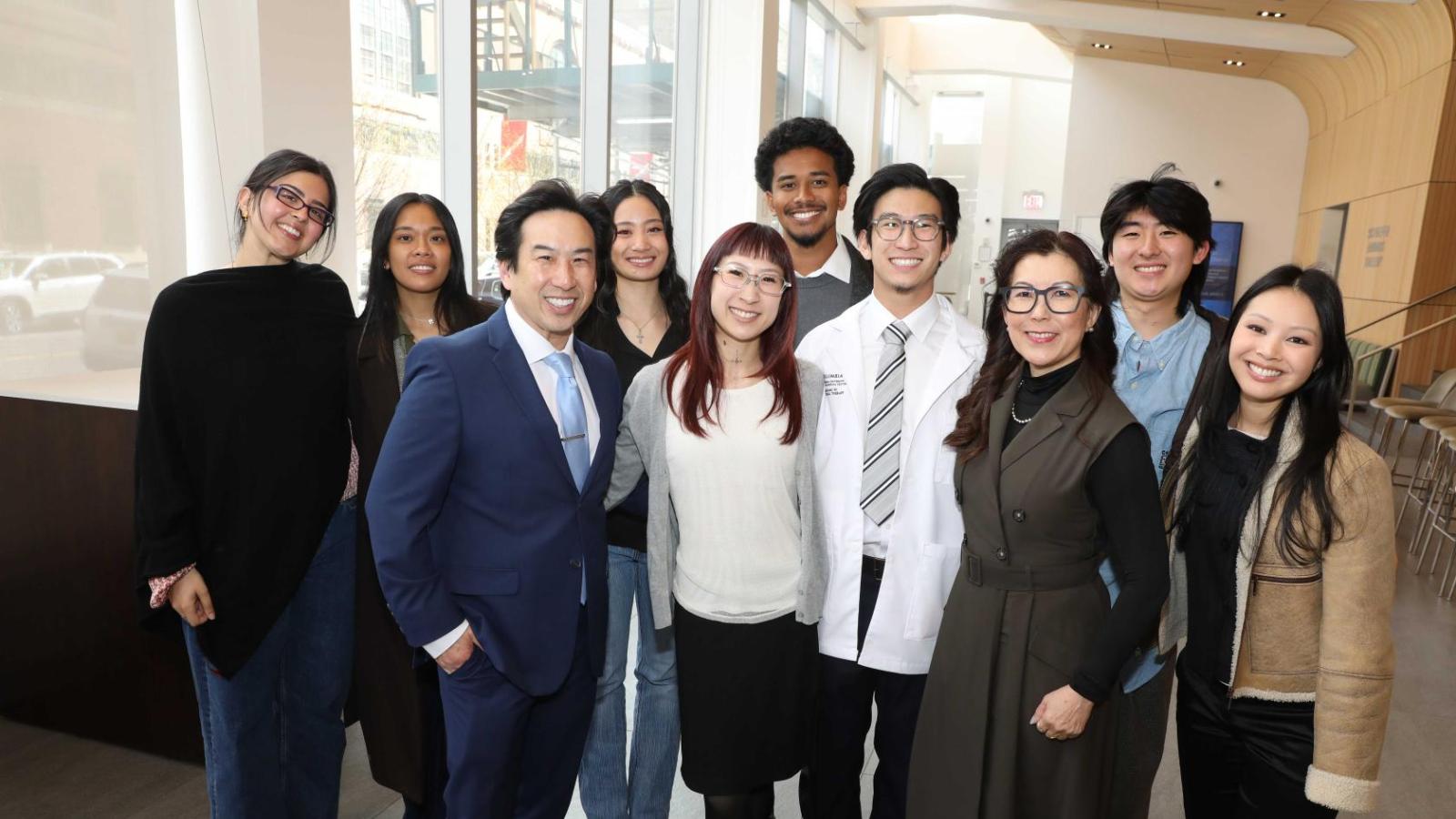 Family and friends of a Columbia physical therapy student pose together for a group photo during the white coat ceremony.