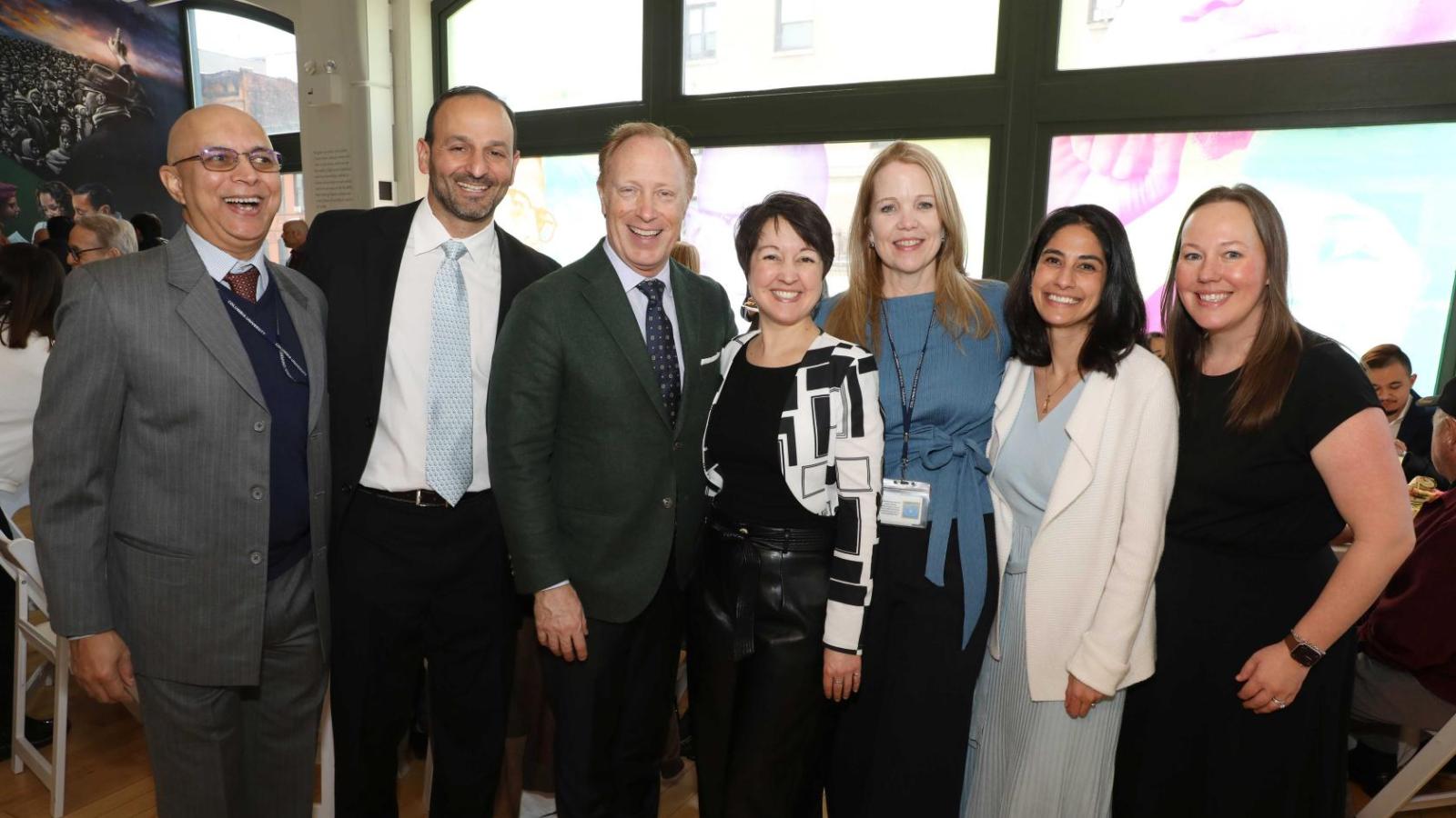Columbia physical therapy faculty and alumni pose together for a group photo during the white coat ceremony reception.