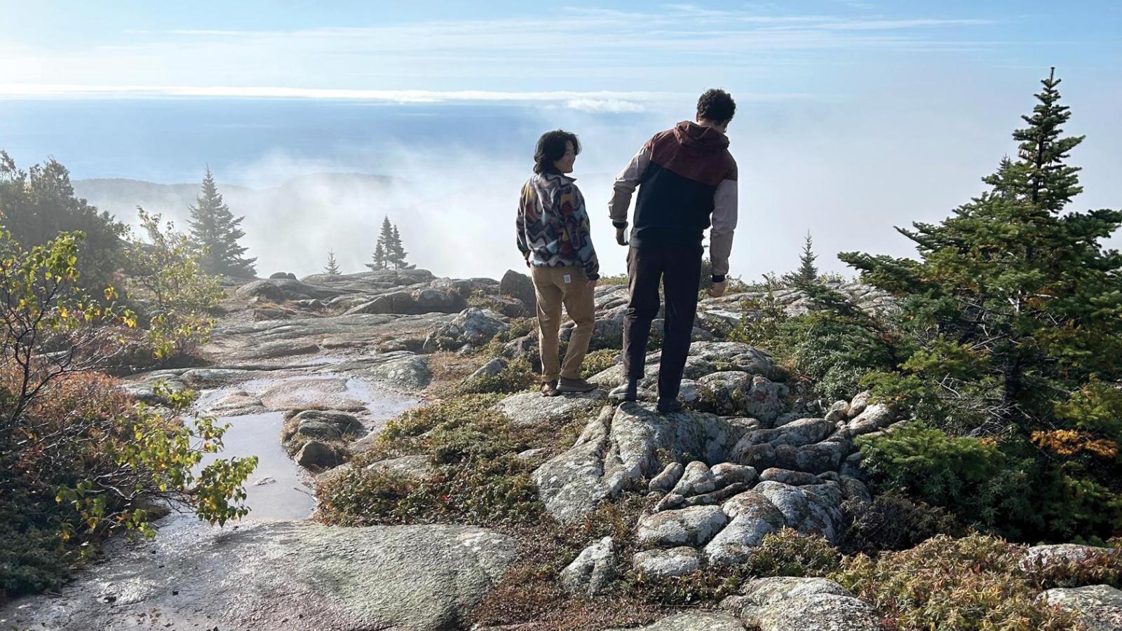 Two people stand on rocks