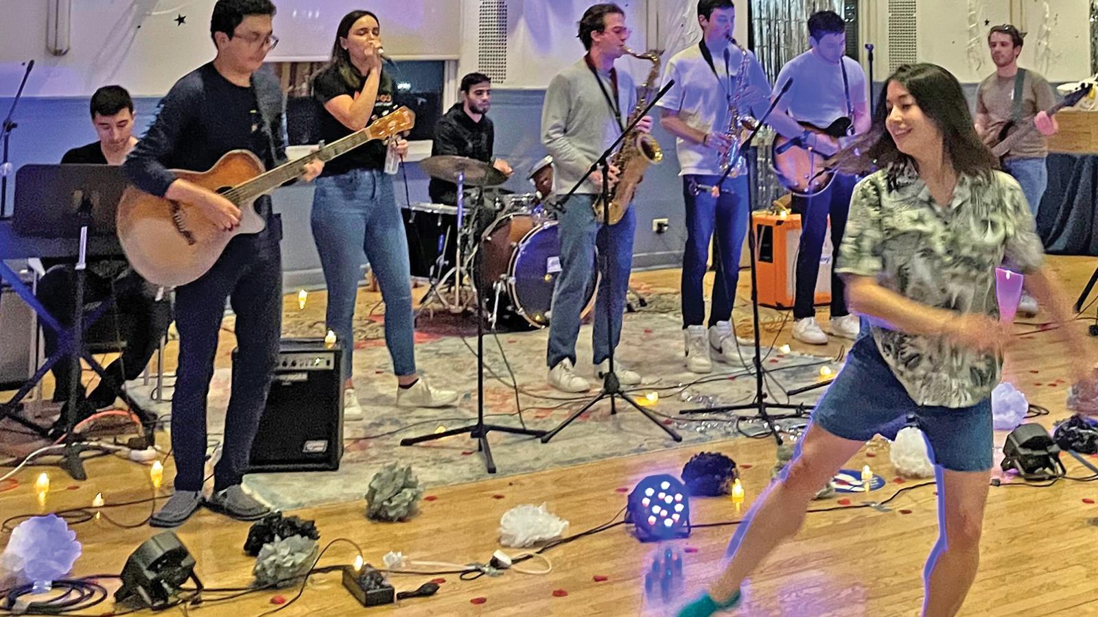 A band performs while people dance in front of them