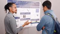Photo of students at poster during poster session.