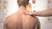 Therapist's hand on back of man's neck
