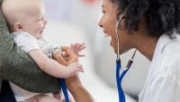 Doctor examines infant with stethoscope