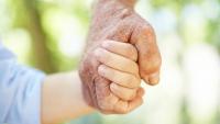 Grandparent holding hand of young child