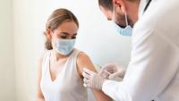 Doctor giving vaccine to a patient