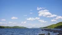 Otsego Lake in Cooperstown, New York, on a partly cloudy day