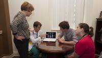 Columbia-Bassett students and faculty review a chart on a laptop computer screen