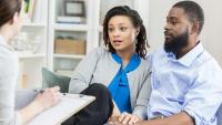 A couple in a counseling session with a clinician