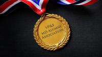 A gold medal that reads "VP&S MD Alumni Association"