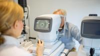 An older patient getting an eye exam with special equipment
