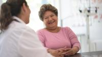 older hispanic woman in doctors office with doctor
