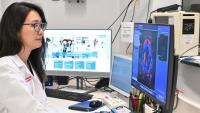 Columbia radiologist Stella Kang, MD, looking at a medical image on a computer