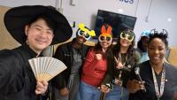 Healthcare staff posing in Halloween costumes and playful character glasses.
