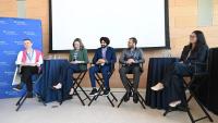 group of five people on a panel discussion