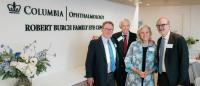 Four people posing in front of the Robert Burch Family Eye Center sign at Columbia Ophthalmology.