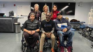 Faculty with Lawrence and patients.